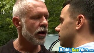 Horny stud fucks mature man in missionary pose in public