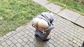 Suited man in grey socks and tie spreading legs