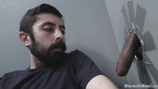 Bearded white man sucking and fucking a black cock at a gloryhole