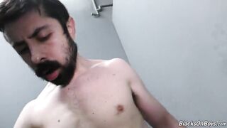 Bearded white man sucking and fucking a black cock at a gloryhole