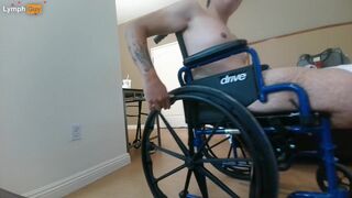 Handicapped guy wheels around hotel room naked in wheelchair