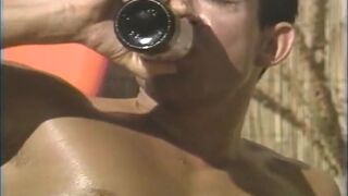 Two Muscular Men Fuck Their Asses with a Double Ended Dildo on the Beach